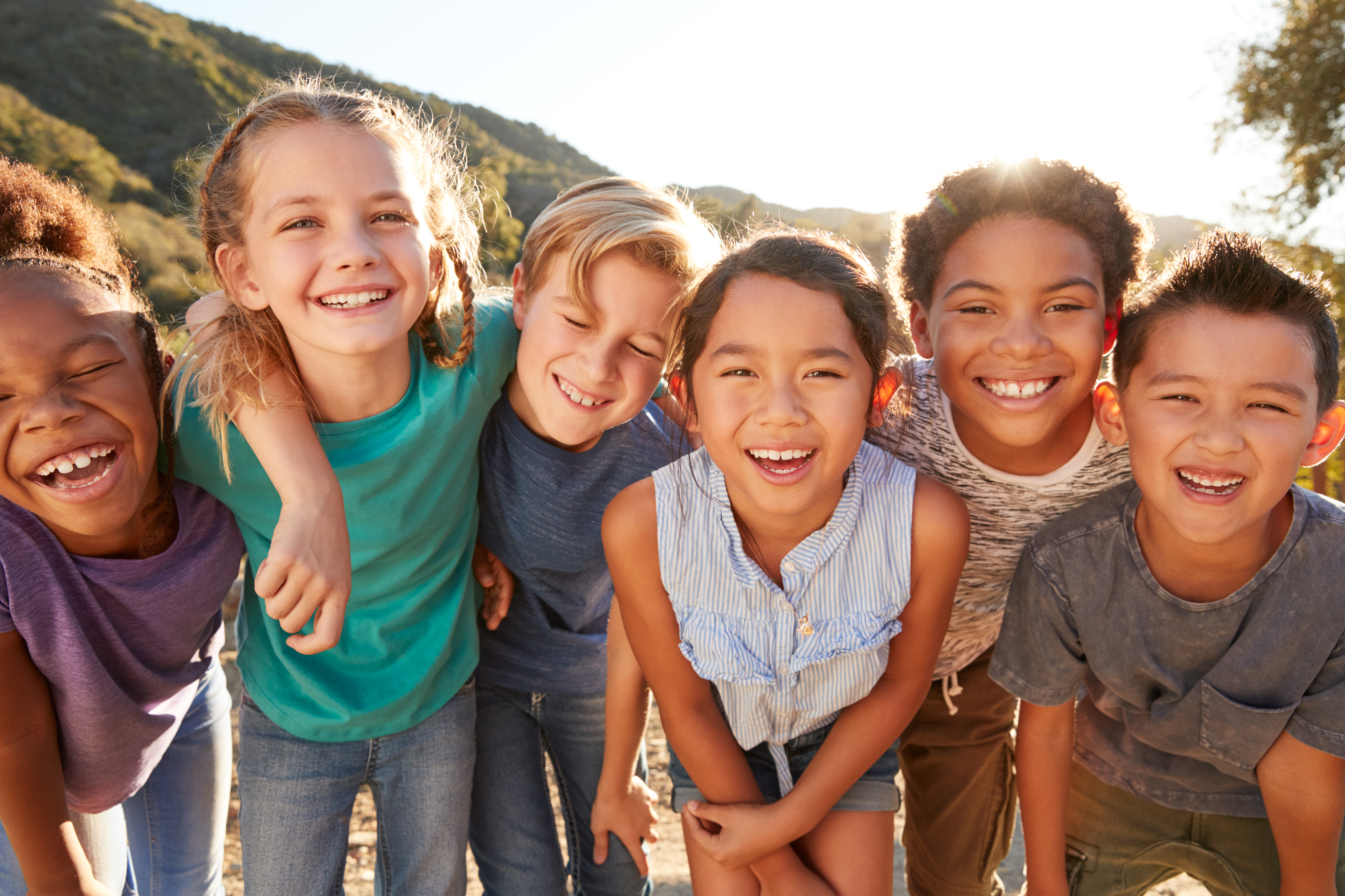 Smiling children holding hands